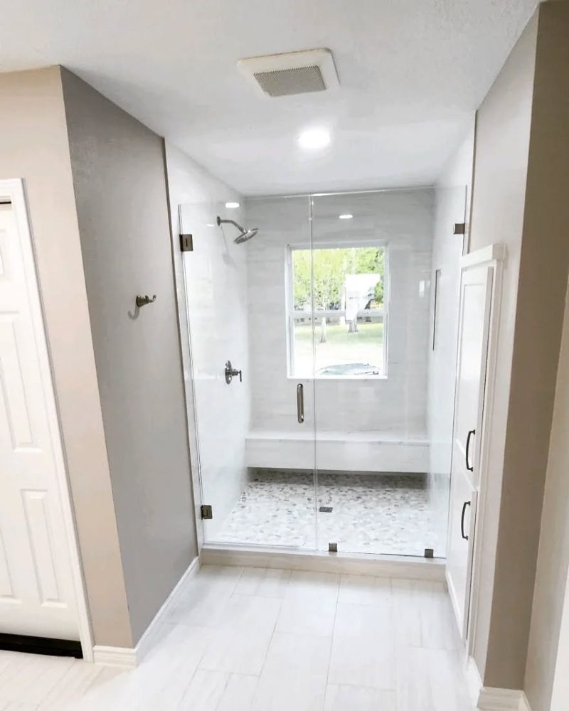 A custom tile shower with natural stone detailing