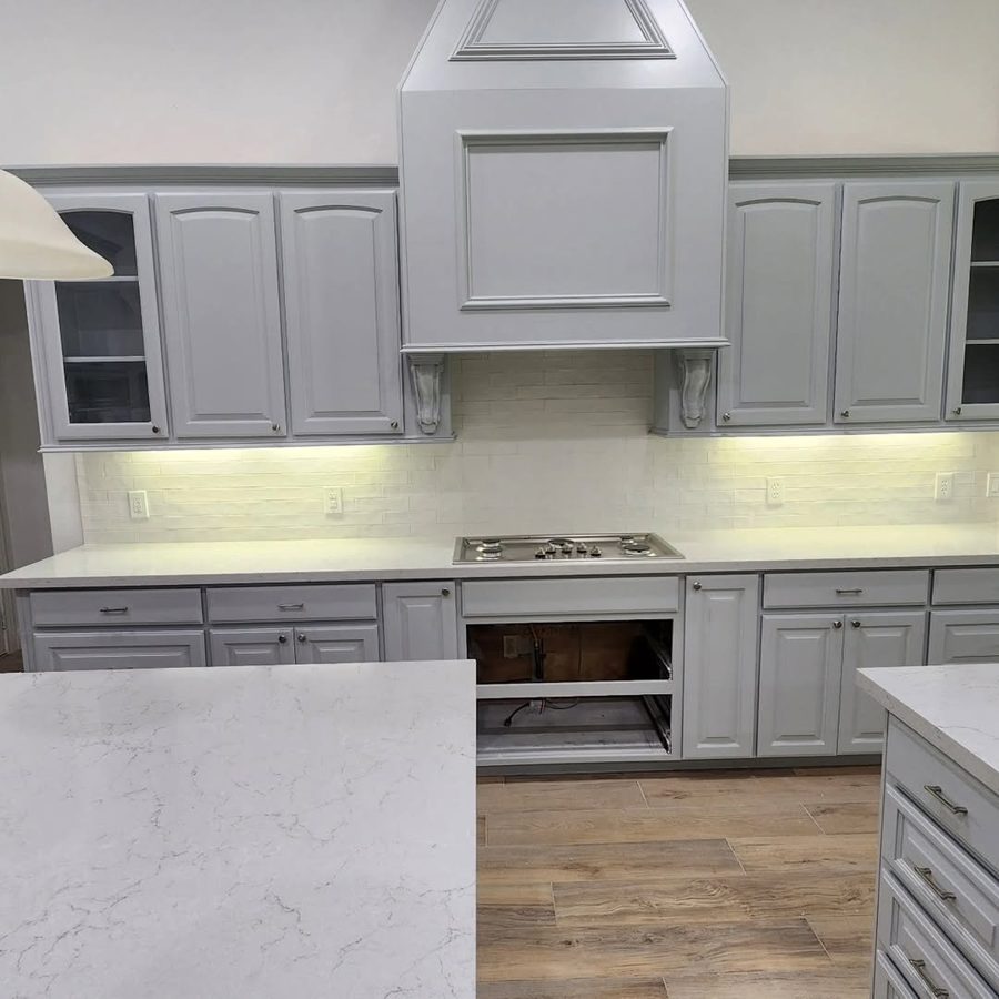 A finished kitchen with new countertops and backsplash tile